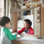 Children and a handmade toy TV